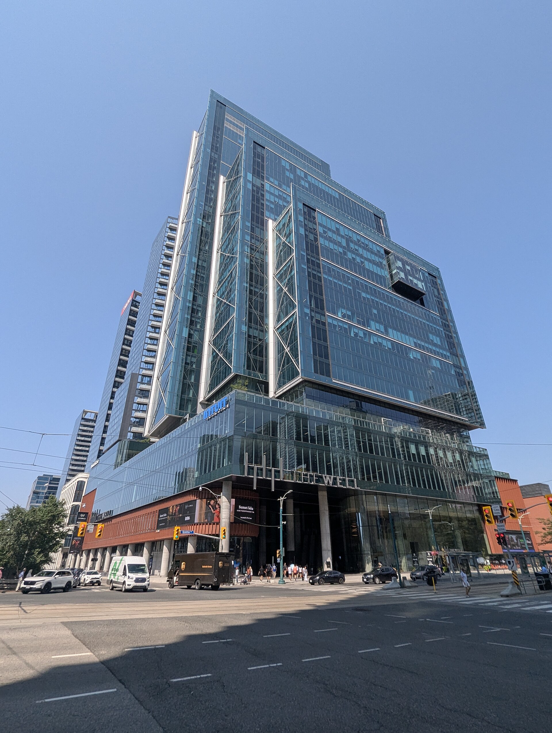 Street-corner view of a tower and podium within Toronto’s The Well development.