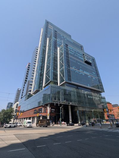 Street-corner view of a tower and podium within Toronto’s The Well development.