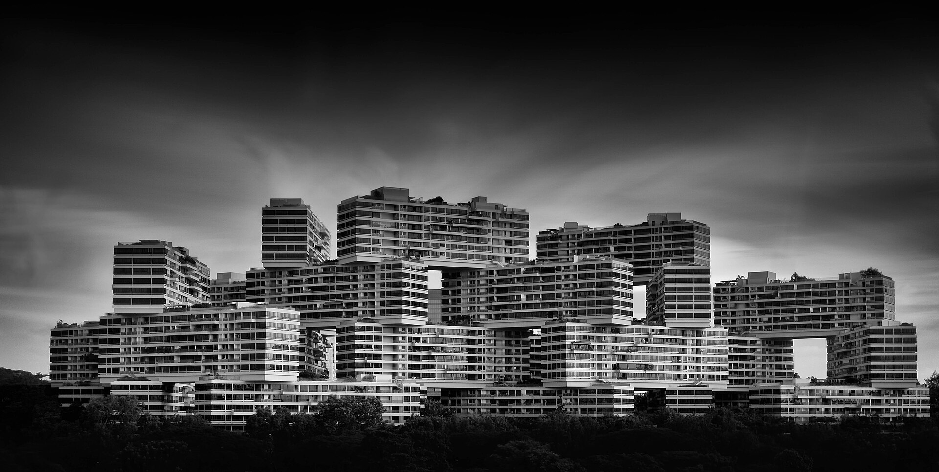 Black-and-white view of The Interlace in Singapore, emphasizing its stacked and interlocking residential blocks.