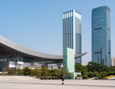 Part of Shenzhen Civic Center’s sweeping roof canopy beside the public plaza, with surrounding office towers.
