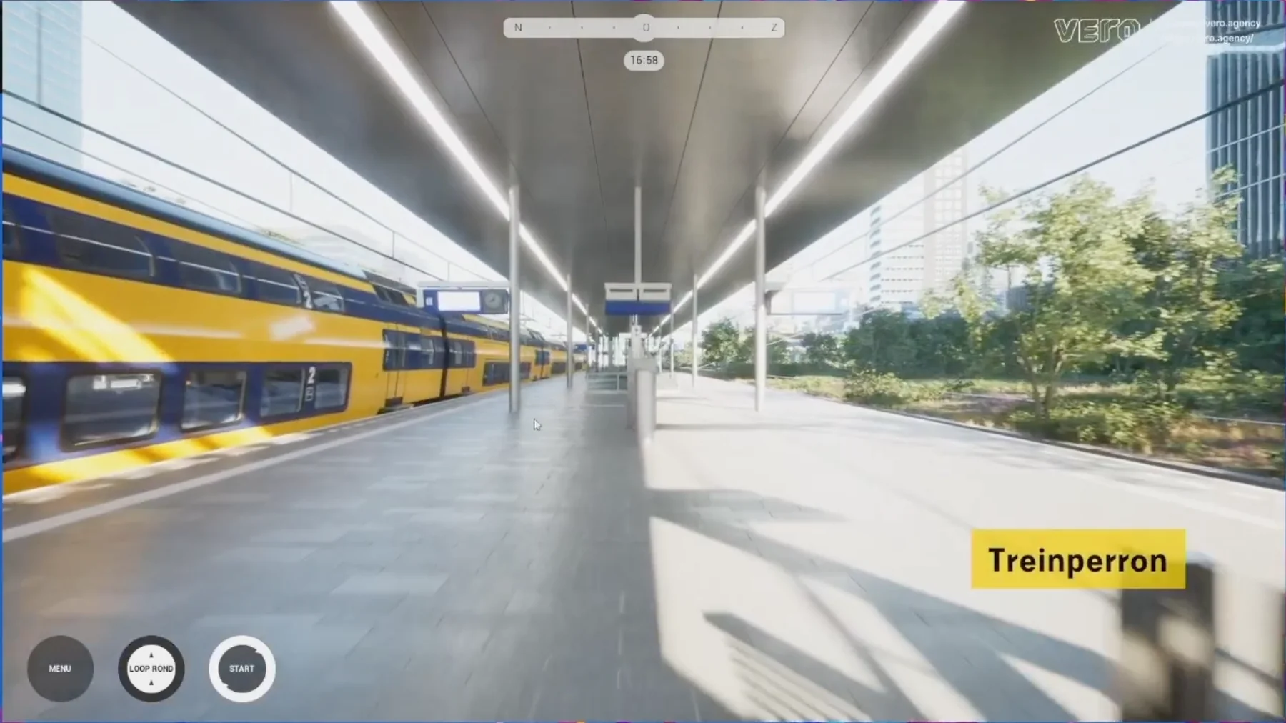 Pedestrian-level view inside the Amsterdam Zuid railway platform model, showing a train, platform canopy, trees, and surrounding buildings.